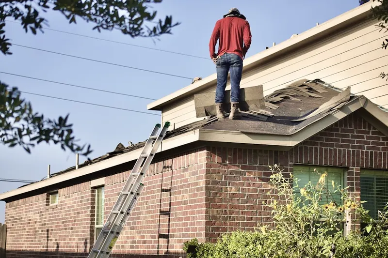 Professional roofer working on a residential roof in Northland Shopping Center